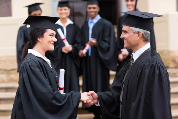 Beautiful graduate handshaking with dean — Stock Photo, Image