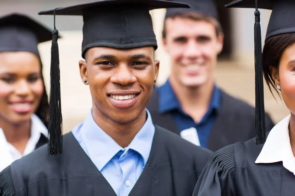College graduates in graduation gown — Stock Photo, Image