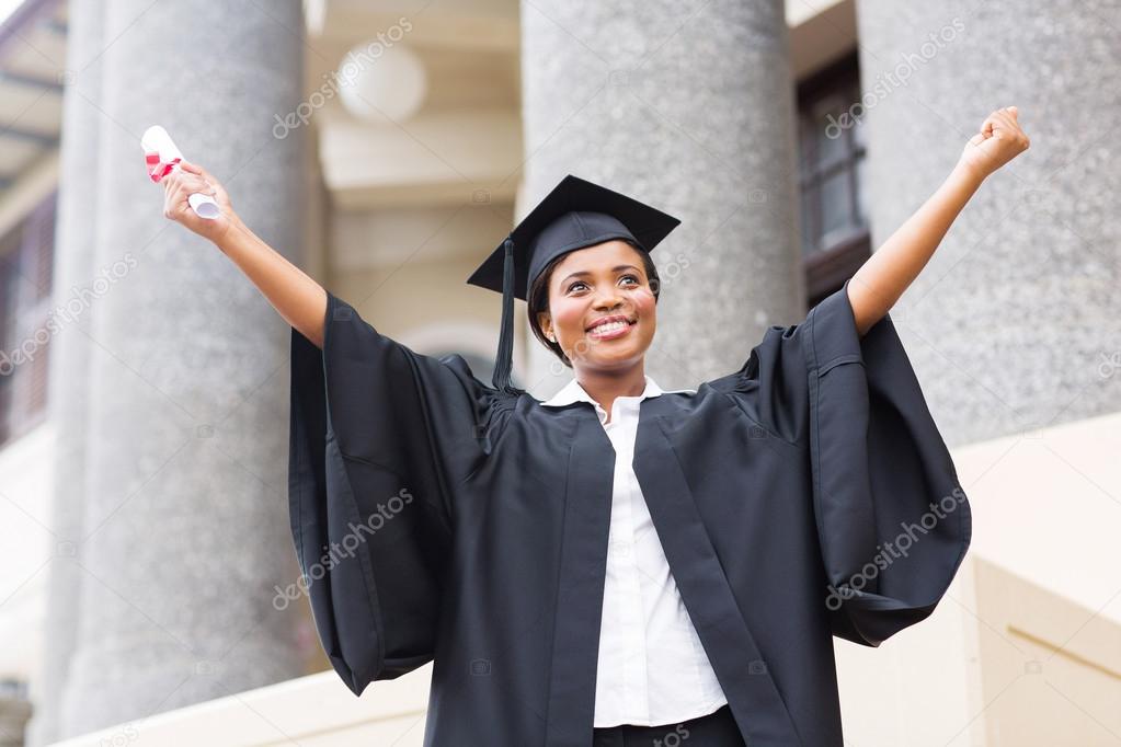 Female student with outstretched arms holding diploma