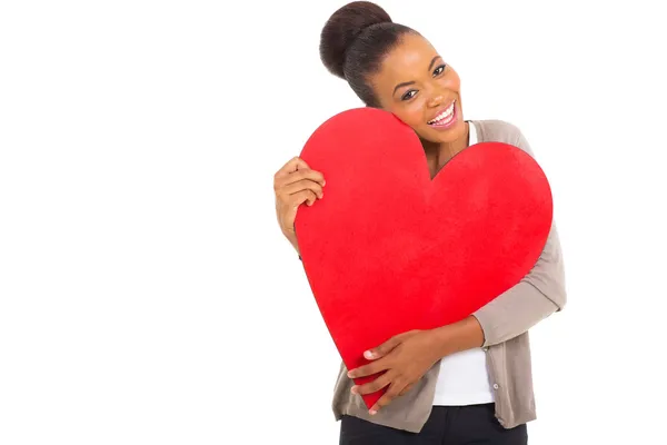 Afro american woman hugging a heart shape — Stock Photo, Image