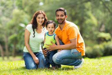 Szczęśliwa rodzina indian na zewnątrz행복 한 인도 가족 야외에서