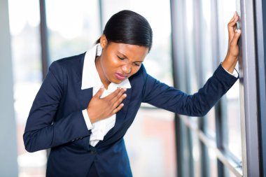 Young african american businesswoman having heart attack clipart