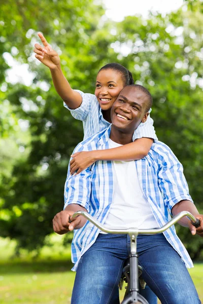 African lovers riding a bicycle outdoors — Stock Photo, Image