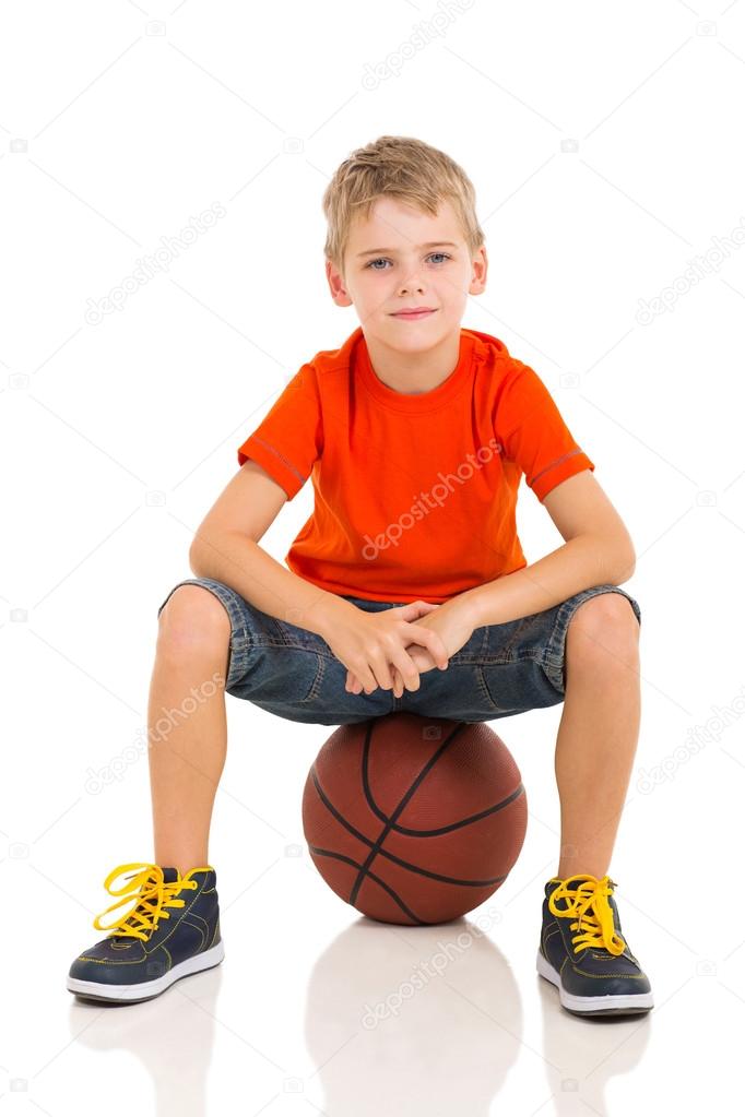 kid sitting on a basketball 