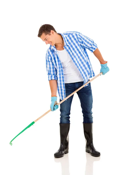 Young man raking — Stock Photo, Image