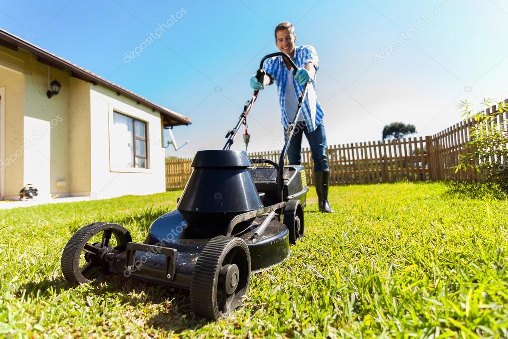 Man mowing lawn at home