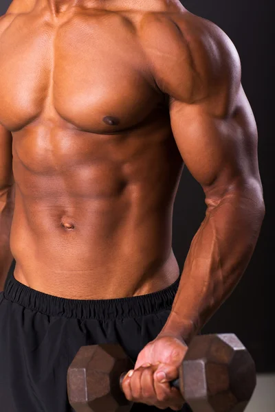 Young african man working out with dumbbells — Stock Photo, Image