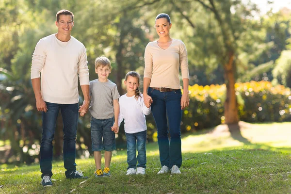 Young family standing outdoors — Stock Photo, Image