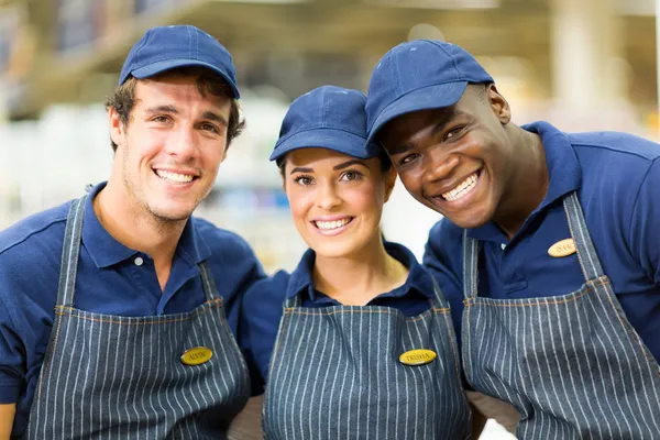 Hardware shop workers embracing — Stock Photo, Image