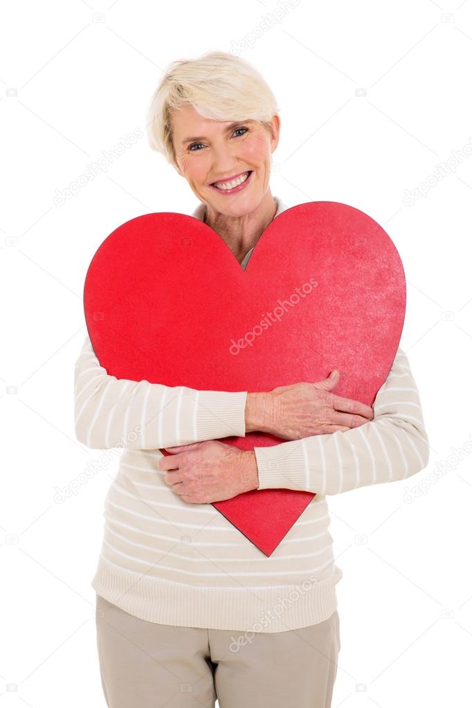 Woman hugging red heart shape