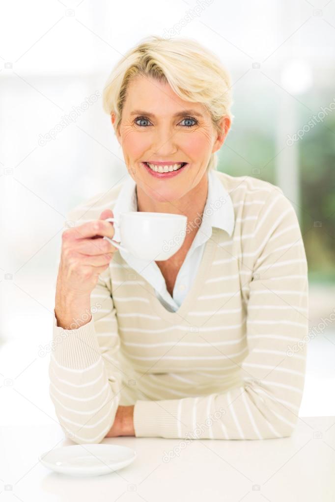 Middle aged woman drinking coffee