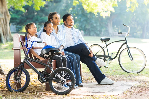 Indian family relaxing in park — Stock Photo, Image