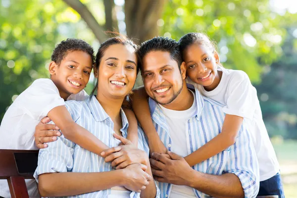 Indian family sitting in park — Stock Photo, Image