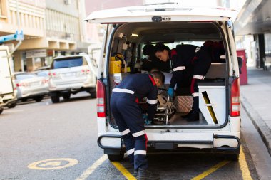 Paramedics offloading patient clipart