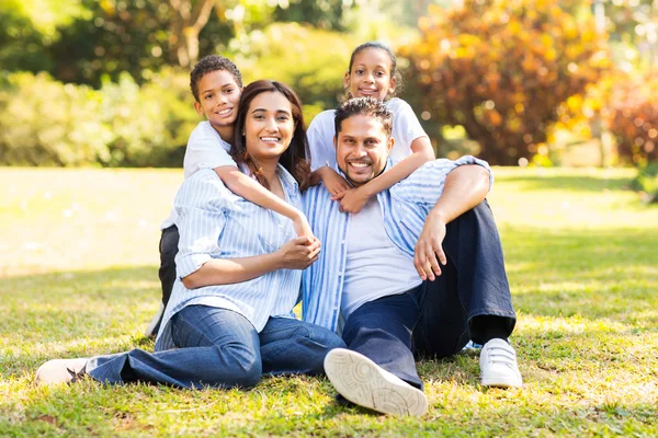 Indian family sitting on grass — Stock Photo, Image