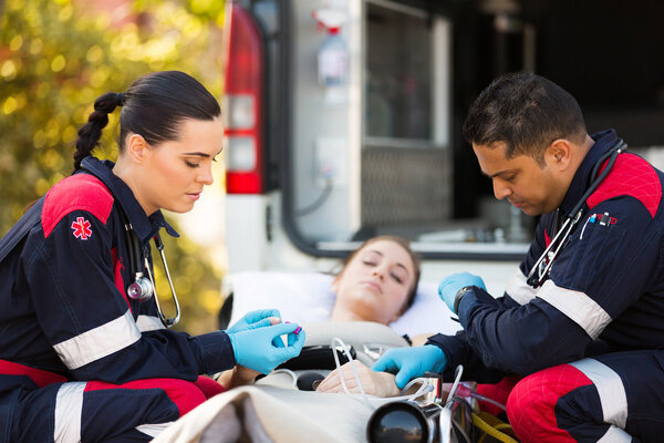 Paramedics giving first aid