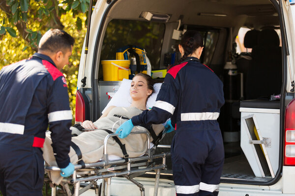 Paramedics transporting patient to hospital