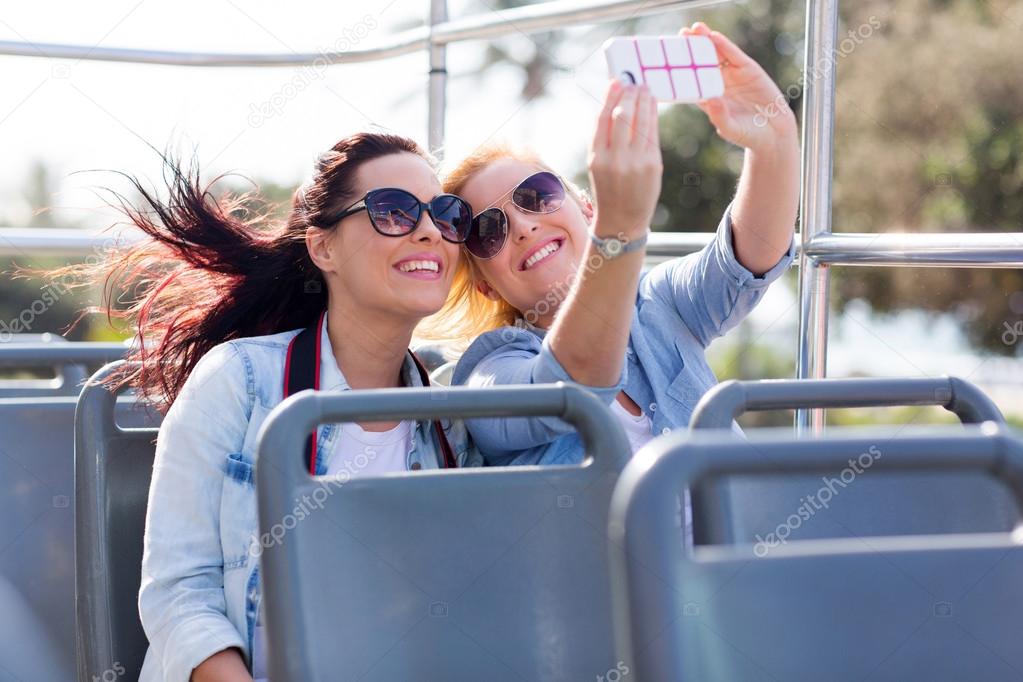Tourists taking selfie with phone