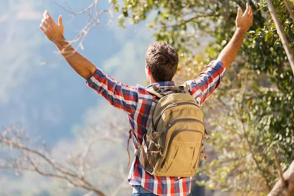 Caminante con los brazos abiertos en la cima de la montaña — Foto de Stock