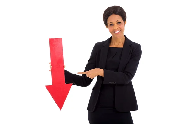 Mature african businesswoman holding red arrow — Stock Photo, Image