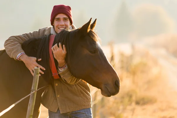 Uomo che abbraccia il suo cavallo — Foto Stock