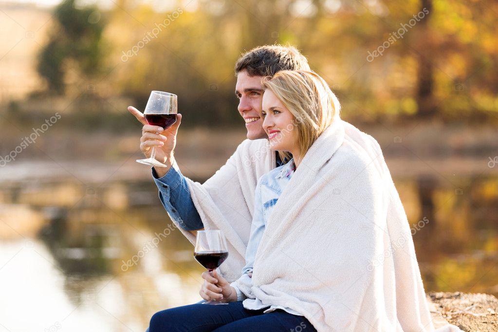 couple sitting together by a lake