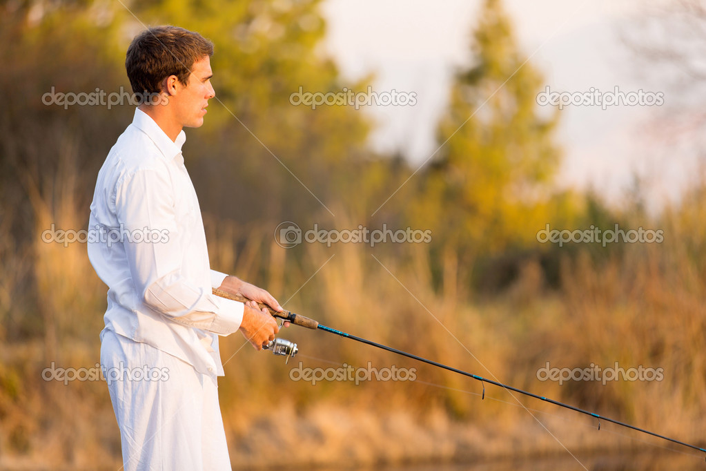 young man holding fishing rod