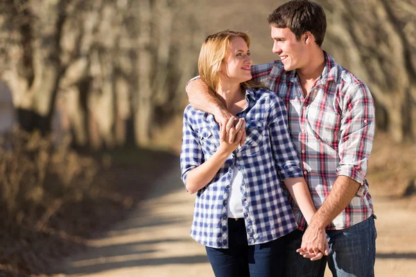 Young couple walking in countryside Stock Photo