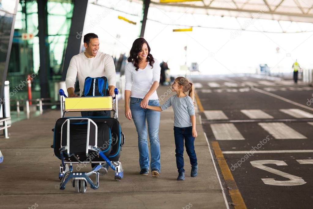 Family with suitcases at airport