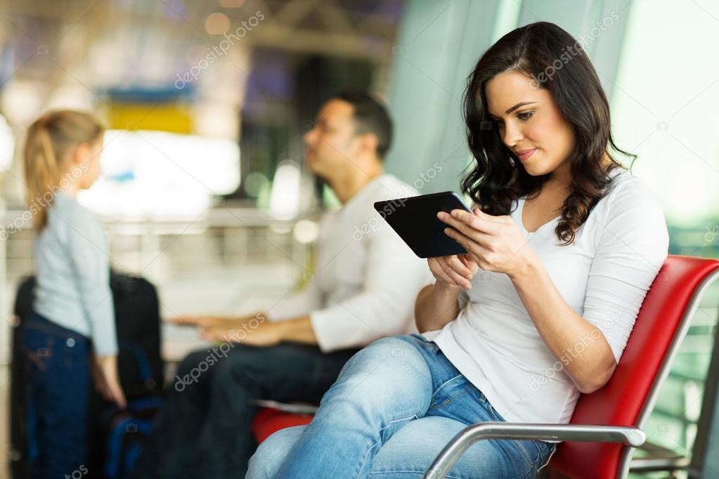 Woman using tablet at airport