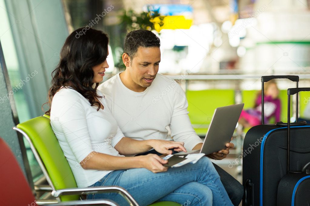 Couple with laptop at airport