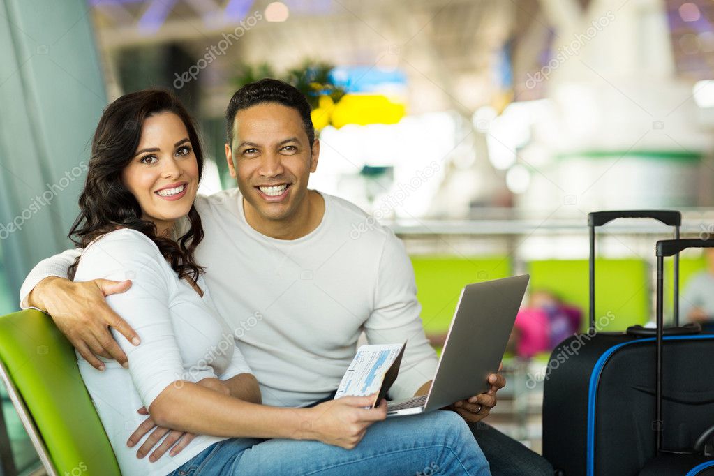 Couple with laptop at airport