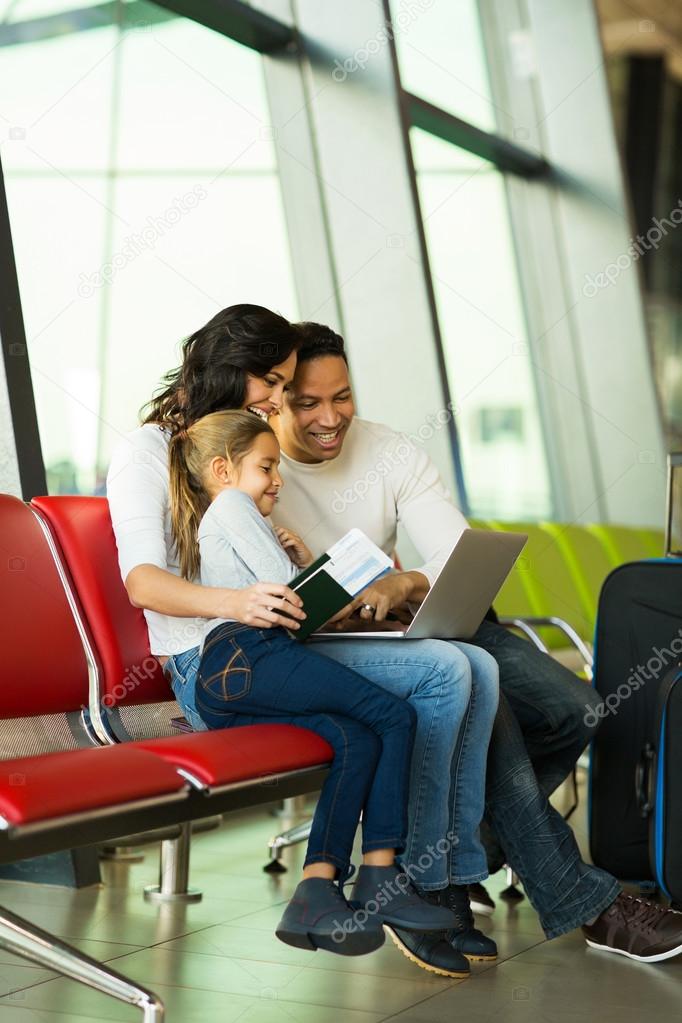 Family using laptop at airport