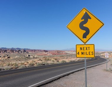 Winding road sign on a scenic desert road in Valley of Fire State Park clipart