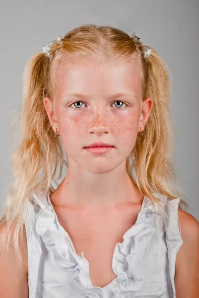 Portrait of blonde girl with a freckled face and two tails — Stock Photo, Image