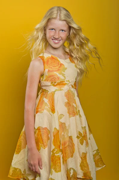 Beautiful blonde girl on a yellow background — Stock Photo, Image