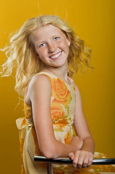 Beautiful blonde girl on a yellow background — Stock Photo, Image