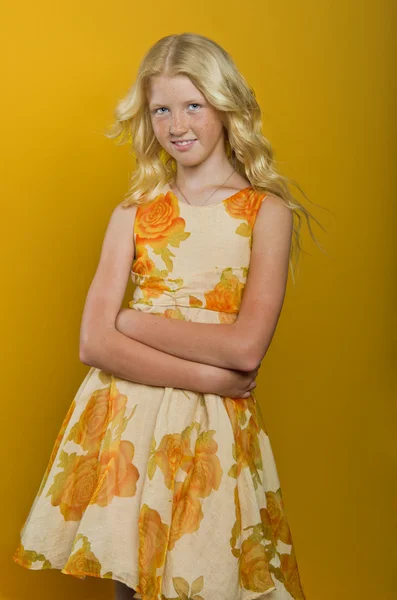 Beautiful blonde girl on a yellow background — Stock Photo, Image