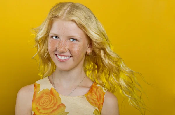 Hermosa chica rubia sobre un fondo amarillo —  Fotos de Stock