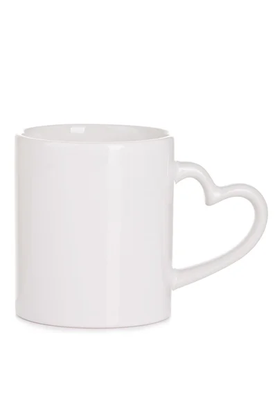 Белая керамическая чашка с рукояткой в виде сердца — стоковое фото
