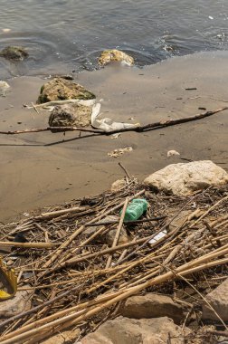Çevre için tehlike - plastik ve çöp ile dünya okyanuslarının kirliliği. Çöplükteki kirli kumsal. Dünya Okyanus Günü - suyu kirlilikten koru.