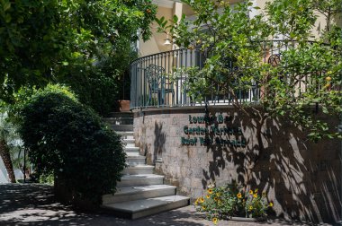 18 Haziran 2022 Sorrento, İtalya. Otellerden birini sıcaktan koruyan ağaçlarla dolu küçük bir bahçe..