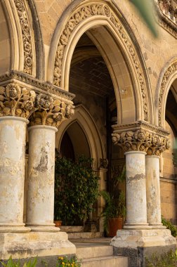 Beautiful authentic arched double doors in the city of Naples. Ancient Streets of the city in the south of Italy. Arched entrance with carving to the monastery (church)