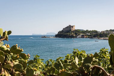 Aragonese Castle (Castello) is a castle next to Ischia, at northern end of the Gulf of Naples, Italy. Beautiful sea view with historical architecture. Calm sea, blue sky and rest on yachts and boats