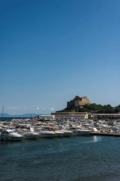 Aragonese Castle (Castello) is a castle next to Ischia, at northern end of the Gulf of Naples, Italy. Beautiful sea view with historical architecture. Calm sea, blue sky and rest on yachts and boats