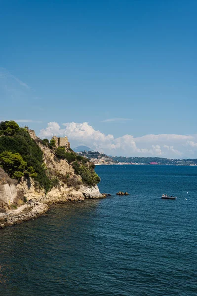 The rocky coast in the south of Italy, the city of Baia. Calm beautiful sea panorama of the Tyrrhenian Sea, European vacation