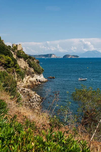 The rocky coast in the south of Italy, the city of Baia. Calm beautiful sea panorama of the Tyrrhenian Sea, European vacation