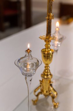 Attributes of the Catholic Church - candles in clay candlesticks on the altar for services