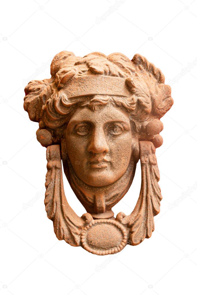 Vintage metal doorknob, knocker (gong) on a red door in the form of a man's head with a laurel wreath isolated on white background