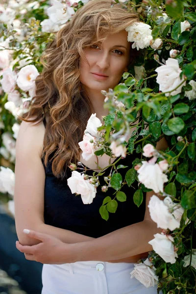 Çiçeklerin yanındaki ofis elbiseleriyle güzel bir bahar kadını..